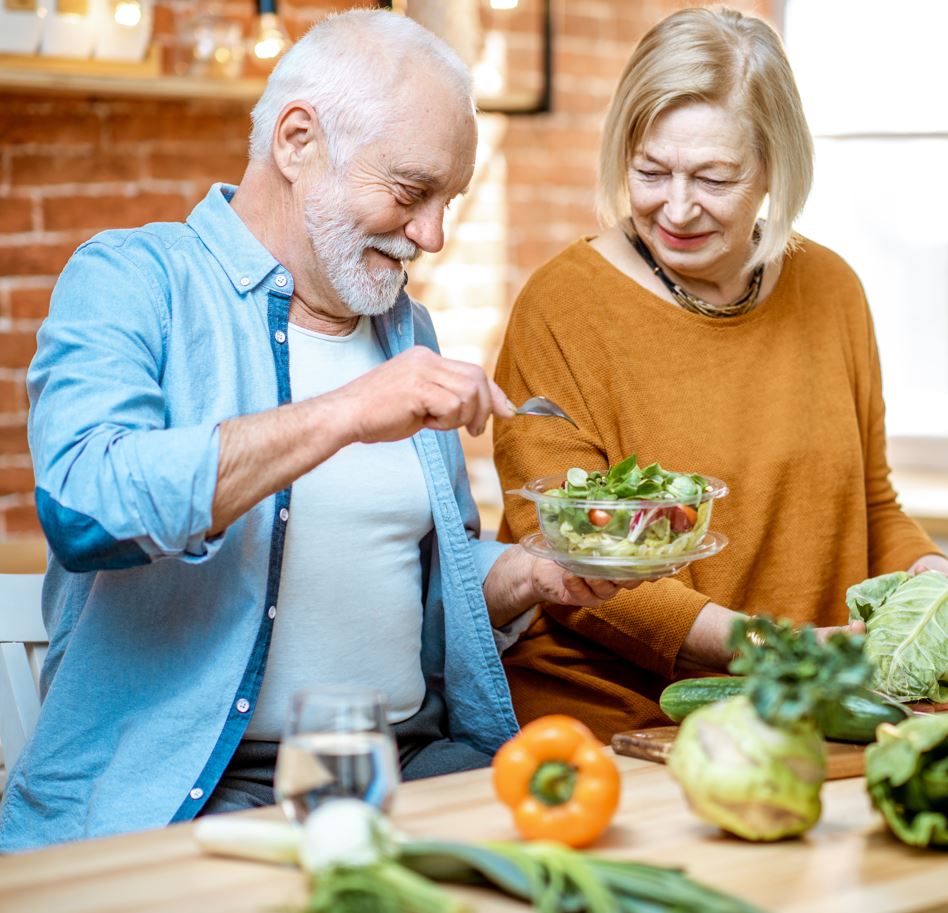 Senior couple preparing a healthy salad