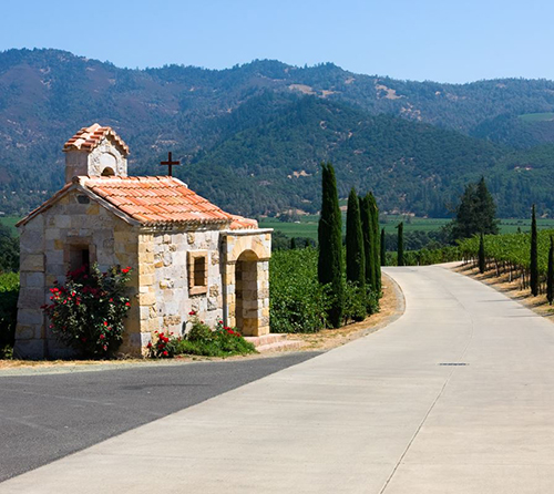 Photo of small church with mountains behind it in California