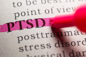 A dictionary with PTSD being highlighting with a pink highlighter